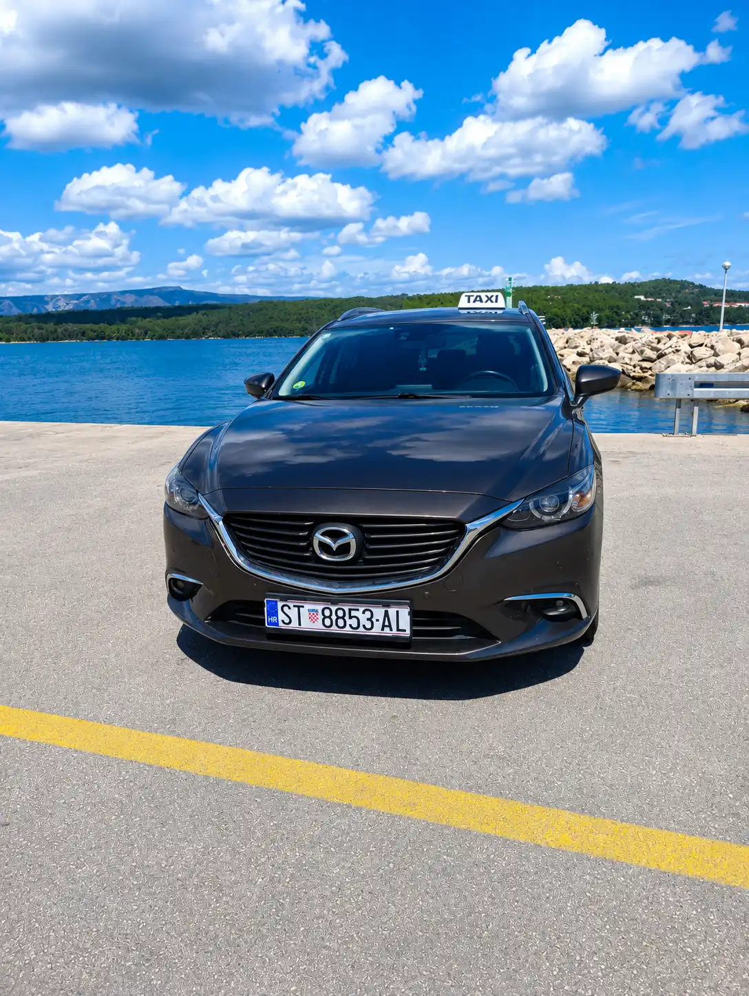 Taxi Hvar Mazda sedan front view by the sea
